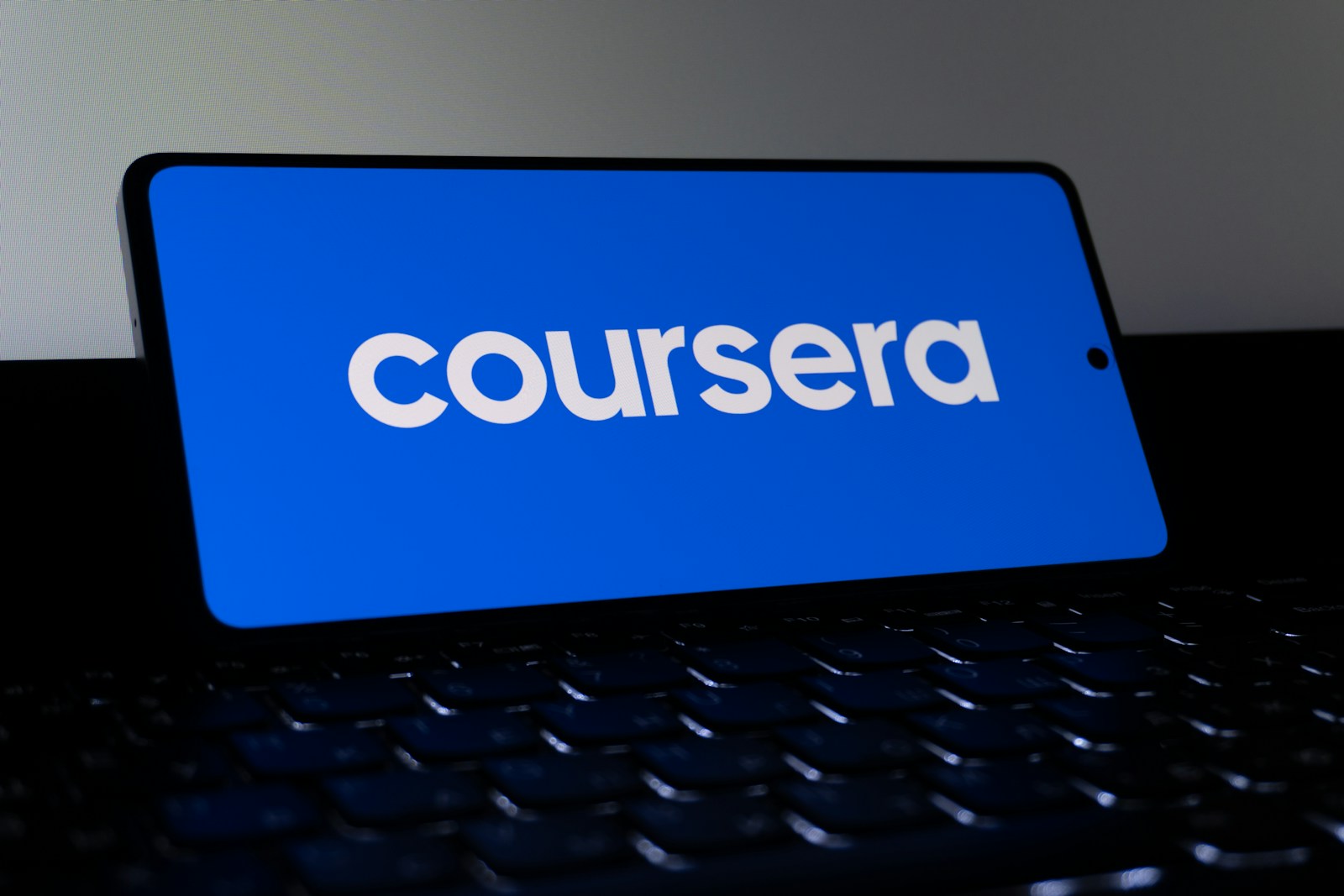 Coursera logo displayed on a smartphone screen.